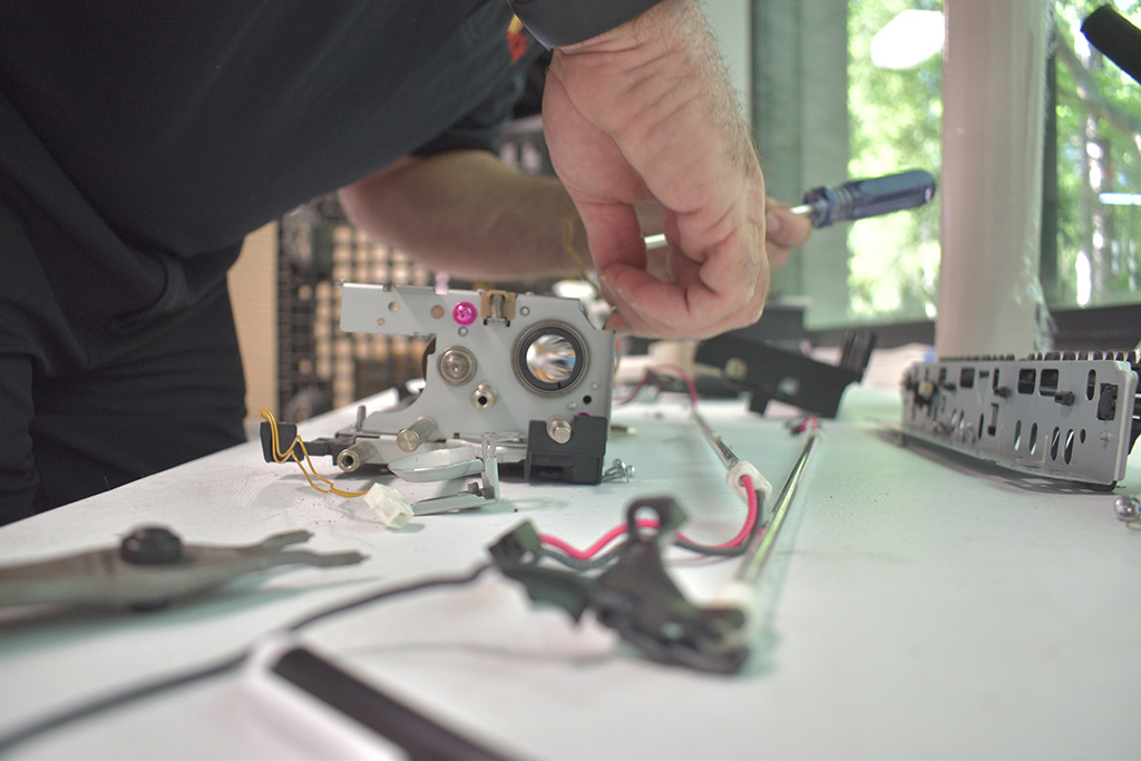 Close-up of printer technician preparing printer for print services.