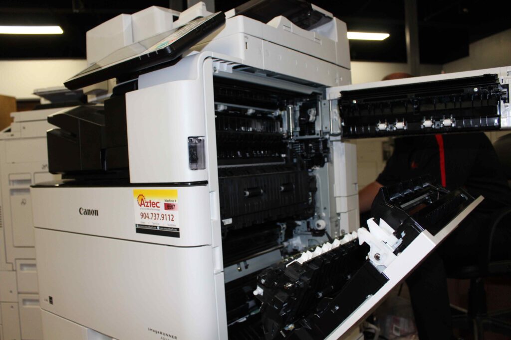 Close up of milt-function printer with open trays.