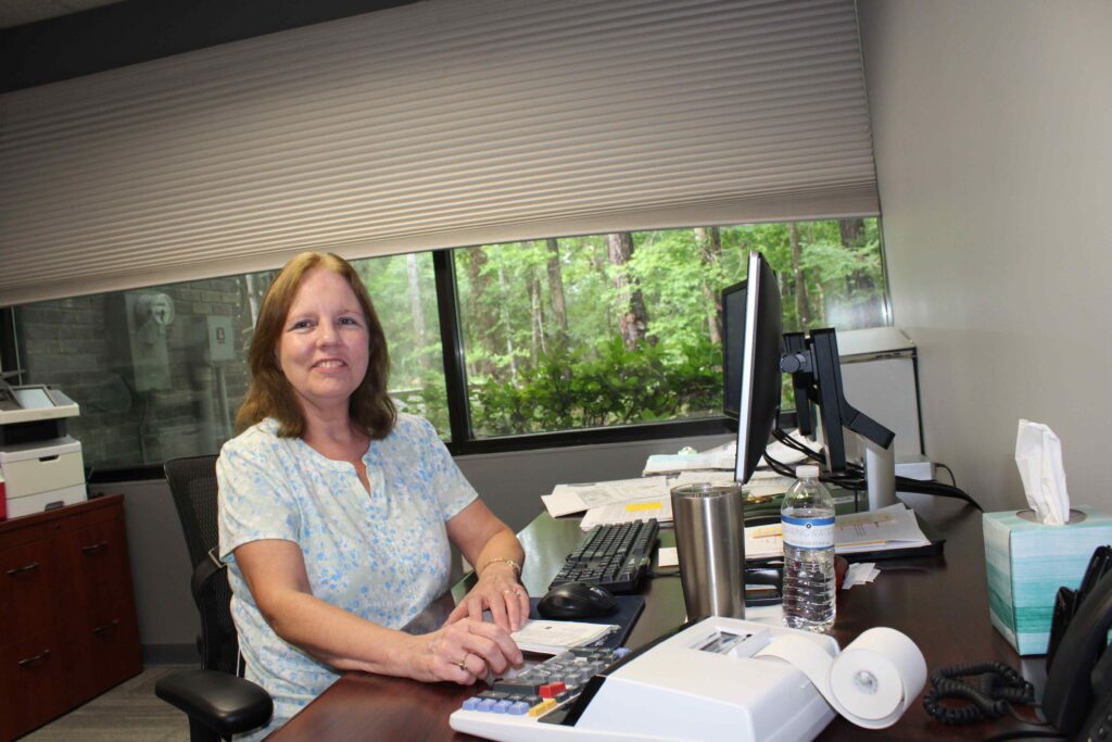 Danese Cox, Comptroller, at desk.